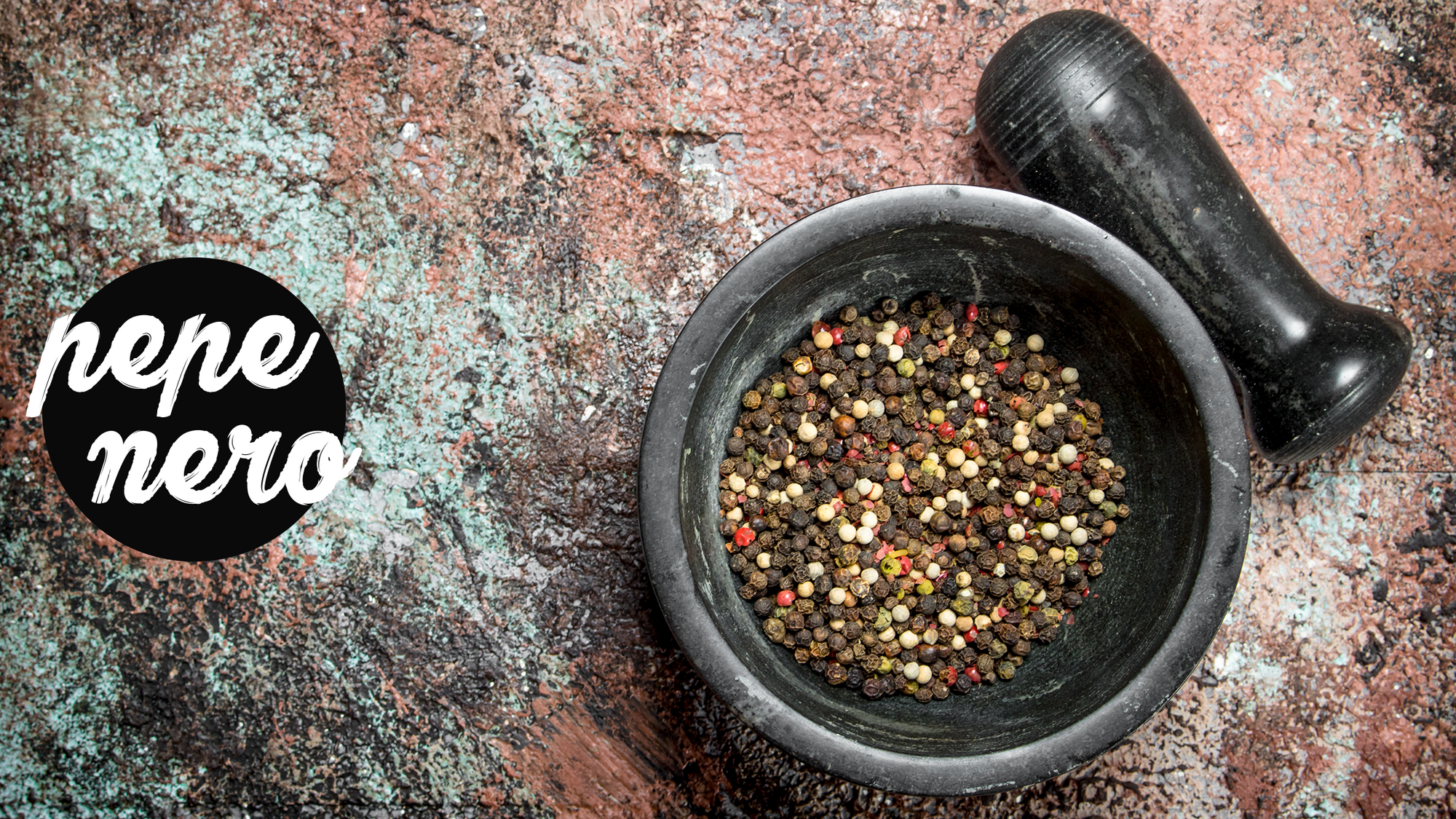 black mortar and pestle with pepper corns