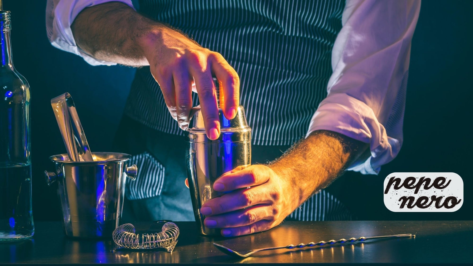 A mixologist using a cocktail mixer to mix drinks